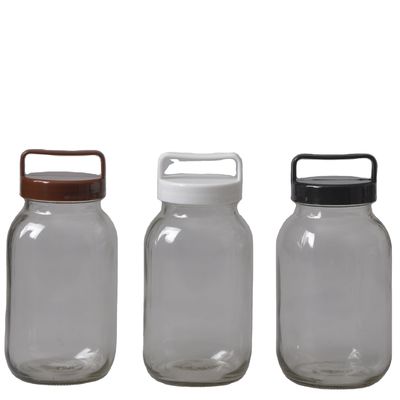Un bocal de verre élégant et transparent avec un couvercle en plastique de couleur 100% sans danger pour les aliments